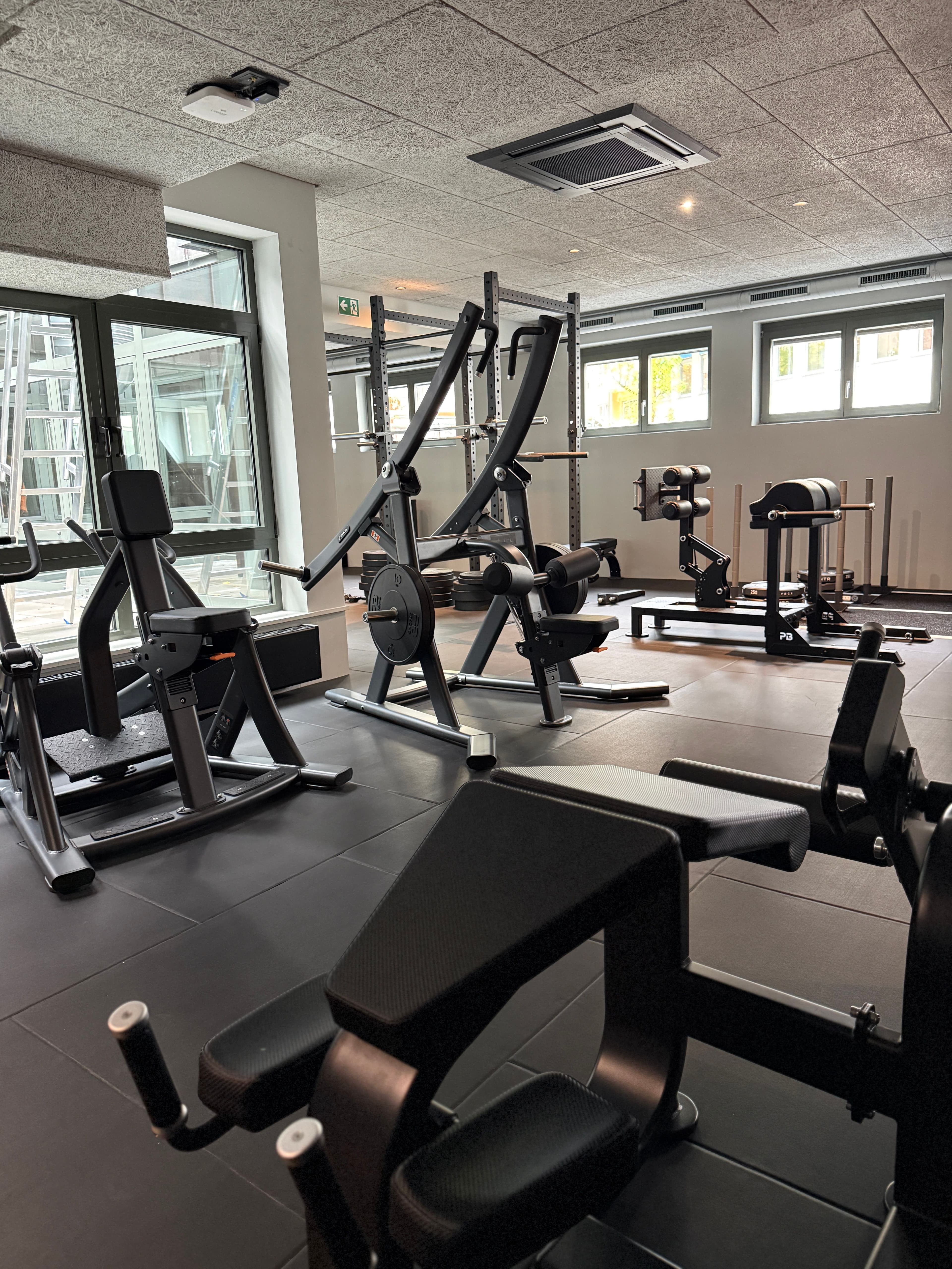 Strength machines, weight plates and racks in the Gym Area at THE BACE.