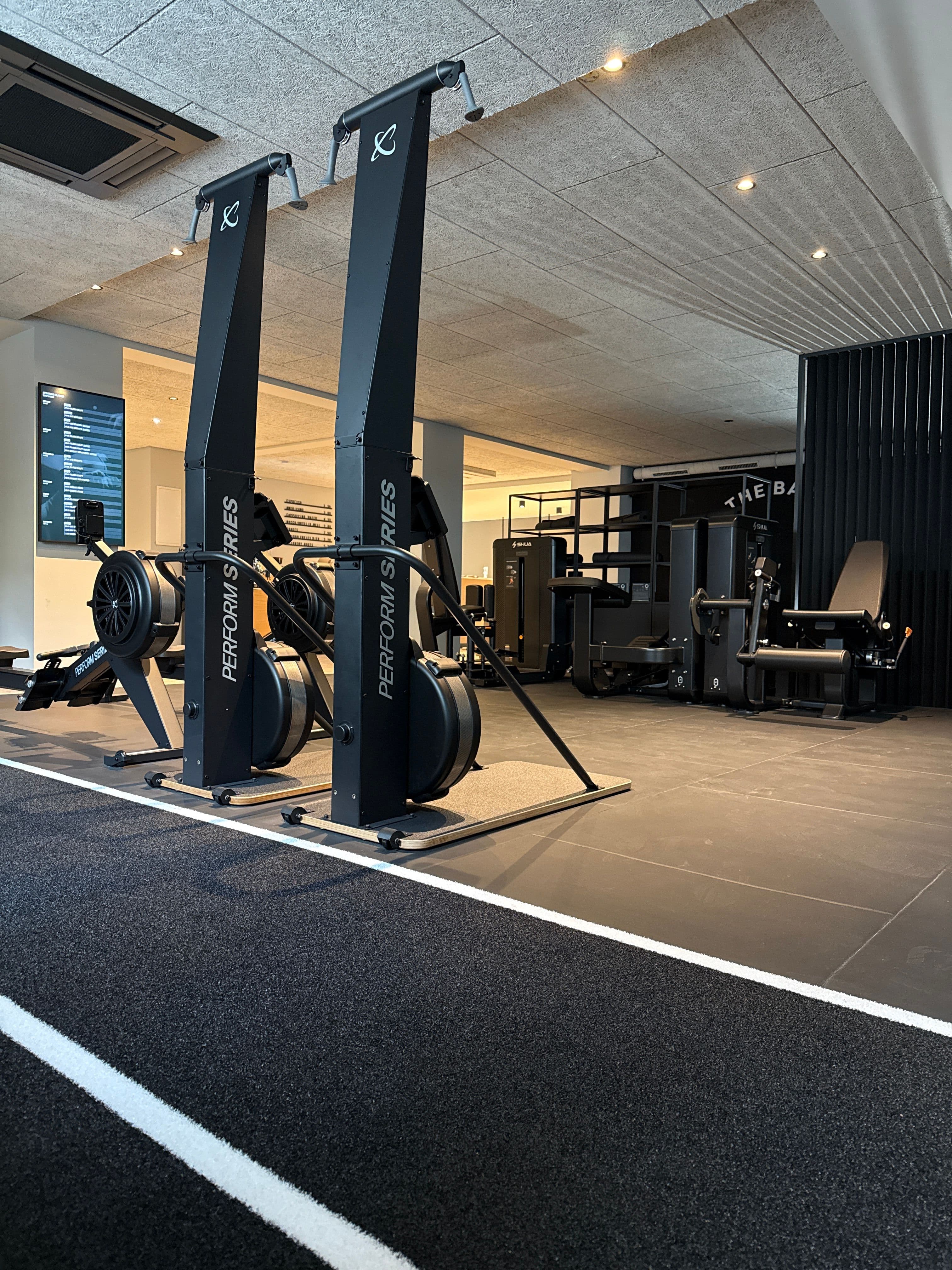 Ski ergometers and rowing machines alongside the marked training lane in the Functional Area.
